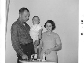 1959 Dec. Dad, Mom, John & creche.jpg